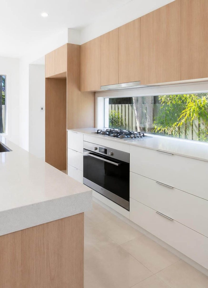 Kitchen after a CleanArt bond clean in Runaway Bay, Gold Coast — oven, gas cooktop, benchtops and cupboards cleaned
